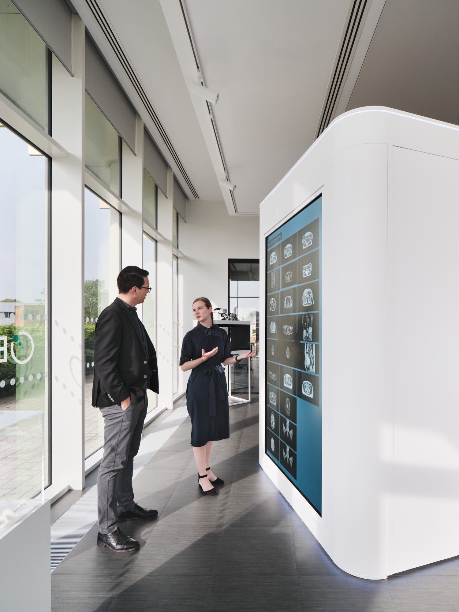 Two people interacting with a screen at Elekta.